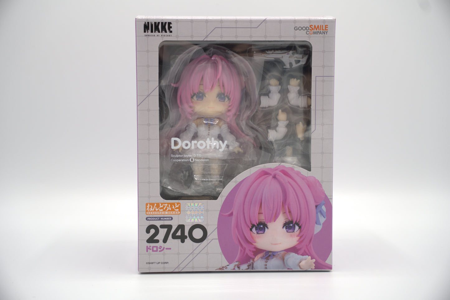 Nendoroid figure packaging with Dorothy from Goddess of Victory: NIKKE, a pink-haired character and visible branding on a white background
